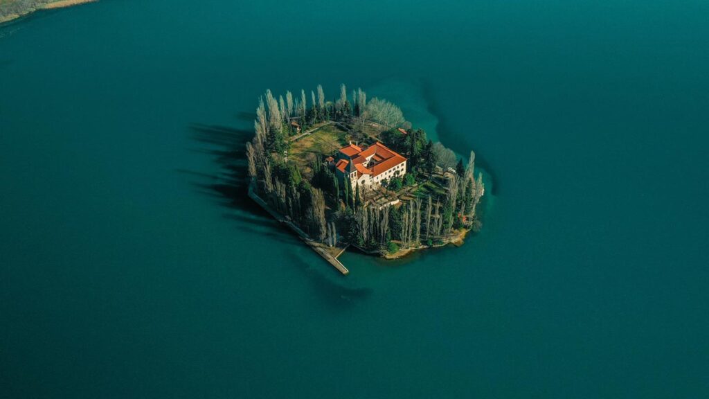 Visovacön med kloster i Krka nationalpark, Kroatien, omgiven av blått vatten.