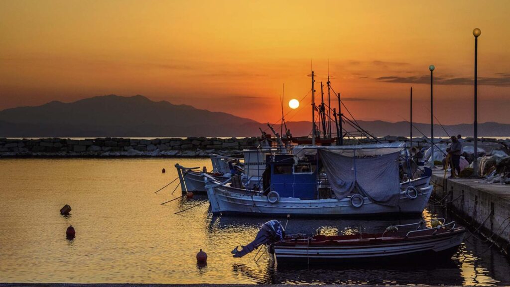 Gamla hamnen i Limenas på Thassos, med spektakulär solnedgång och fiskebåtar.