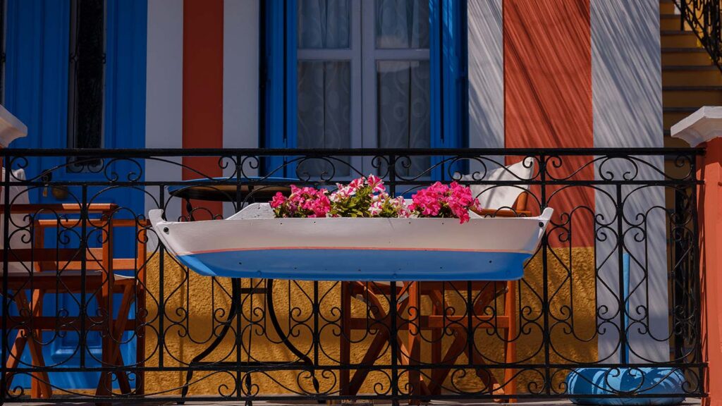 En vacker blomkruka i en båt på en balkong i Symi, Grekland.